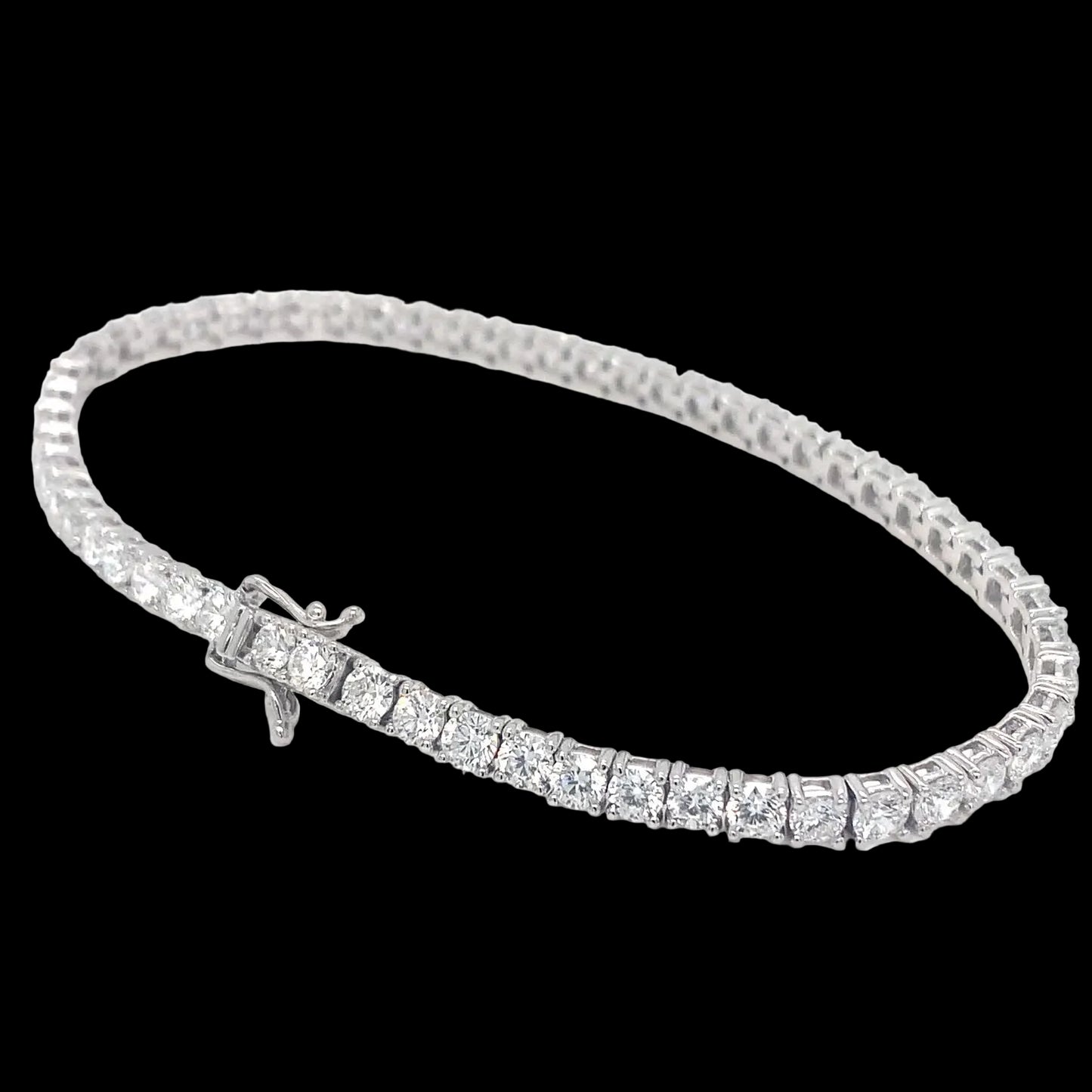 A white gold tennis bracelet with lab diamonds, featuring a series of connected diamond segments on a linked chain.