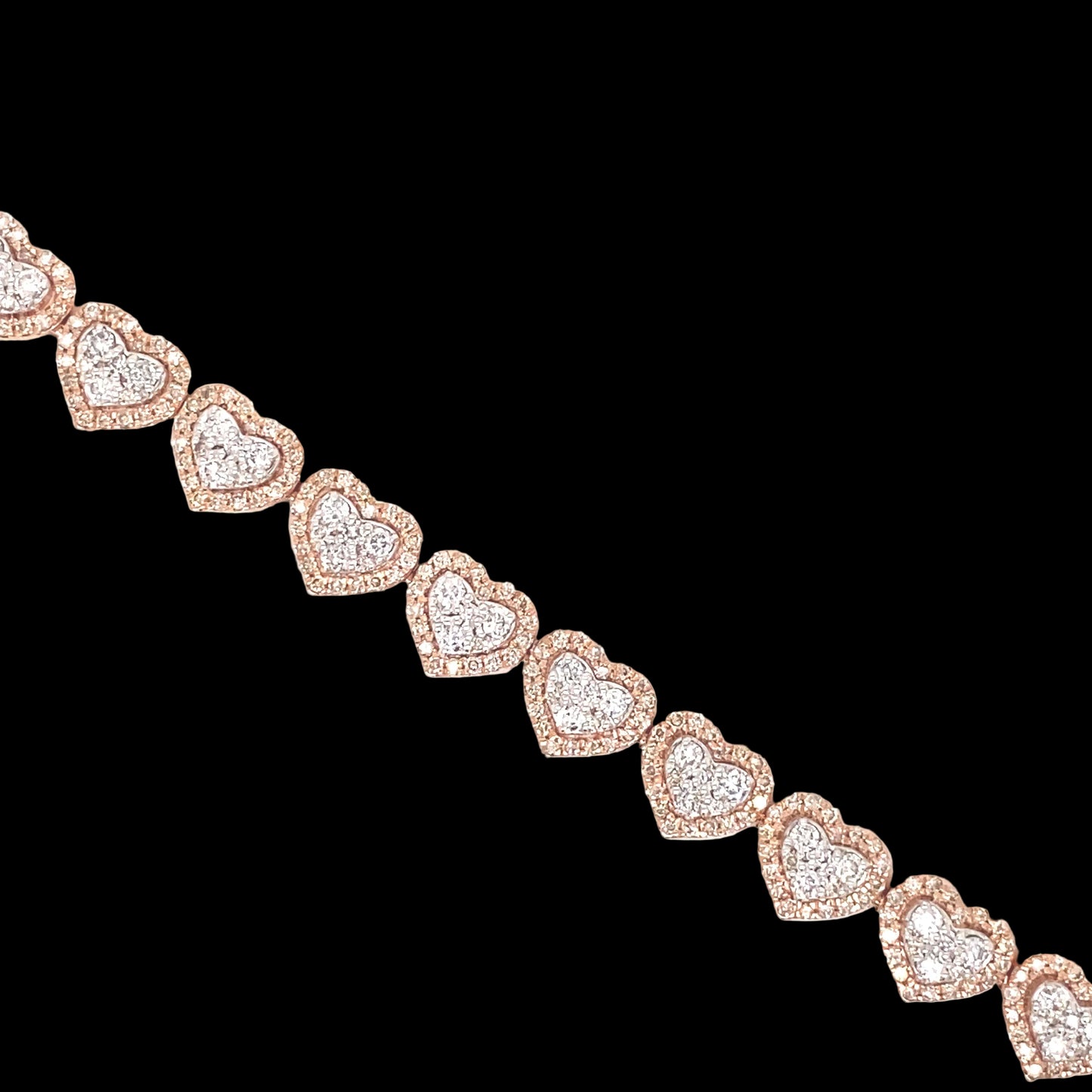 This heart bracelet is detailed with white and rose gold. The diamonds are set in a pave style with rose gold halo hearts.