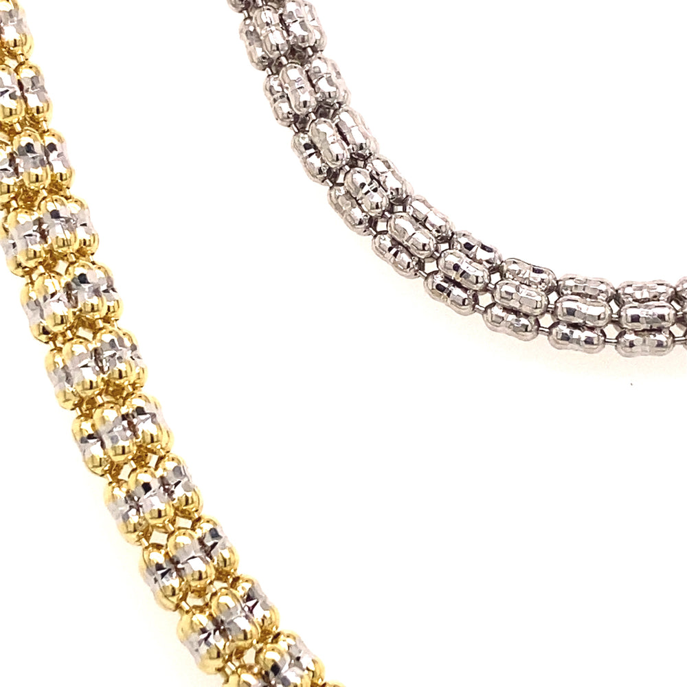 A close display of these white and yellow gold chains show how they're constructed with fine details. 