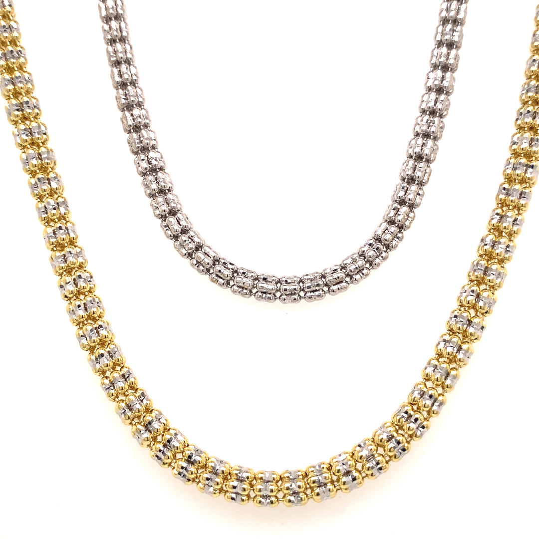 White and yellow gold ice chains are beautifully displayed along each other. 