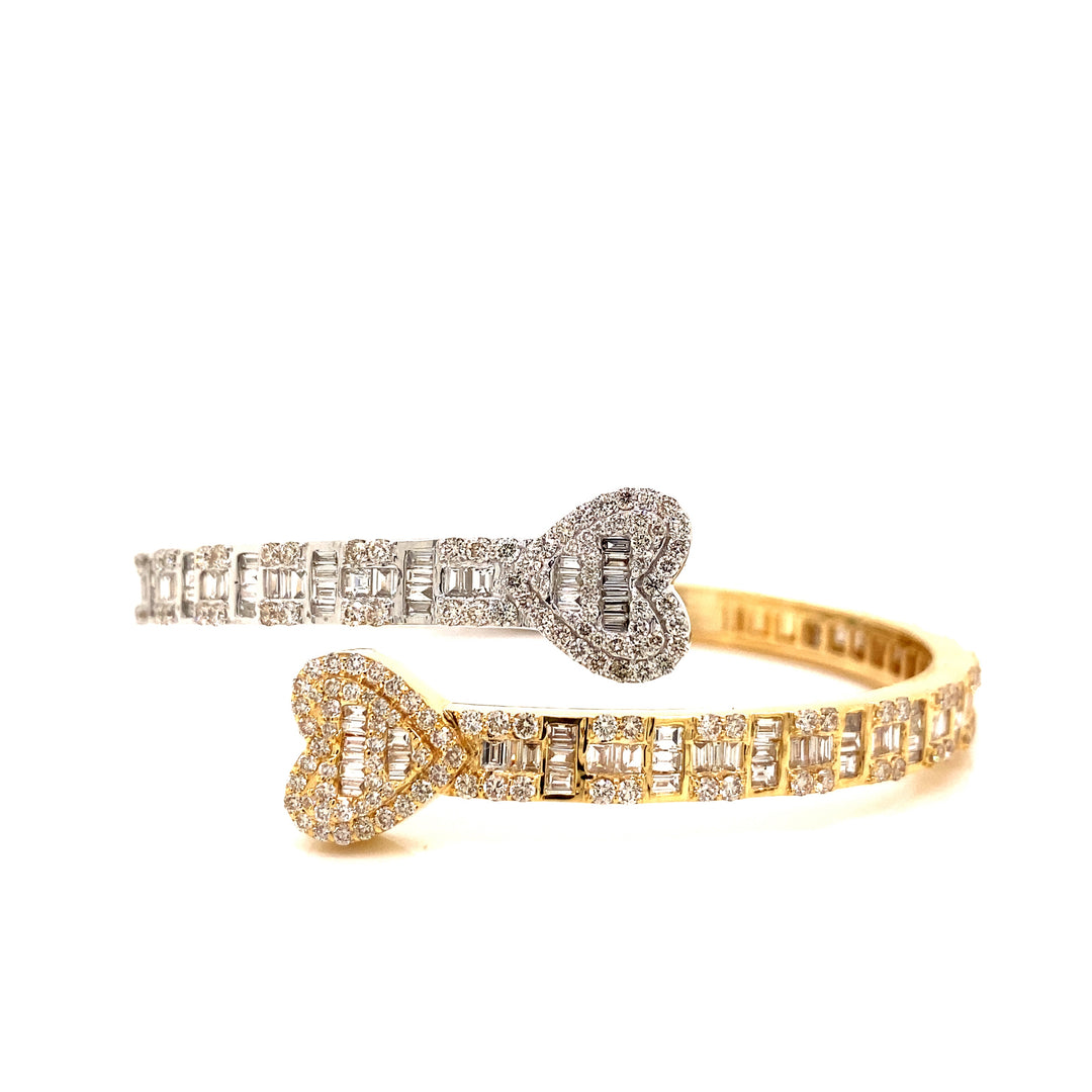 White gold and yellow gold heart bangle with VS clarity diamond stones. 