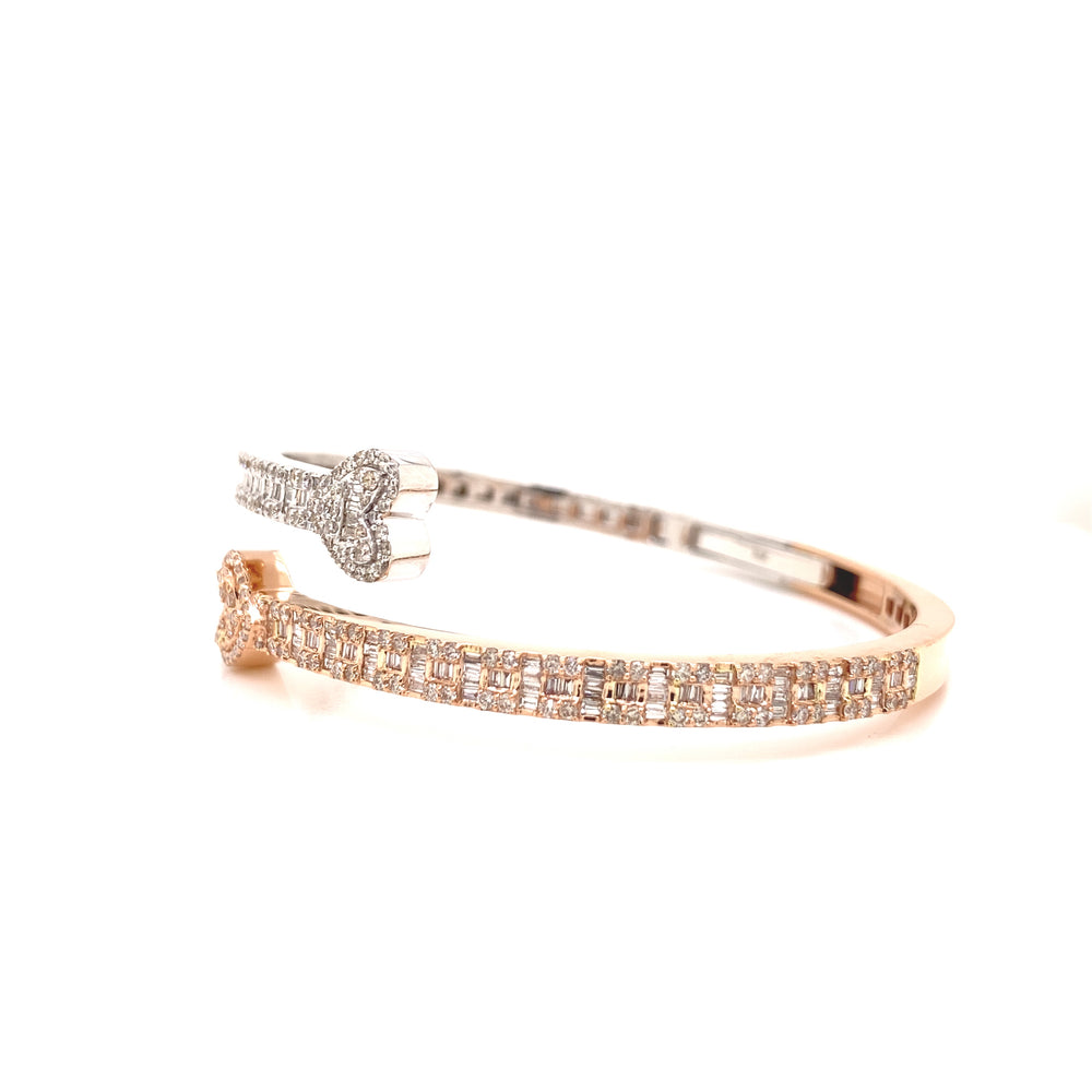 White and rose gold diamond baguette and round bangle with heart shaped closings.
