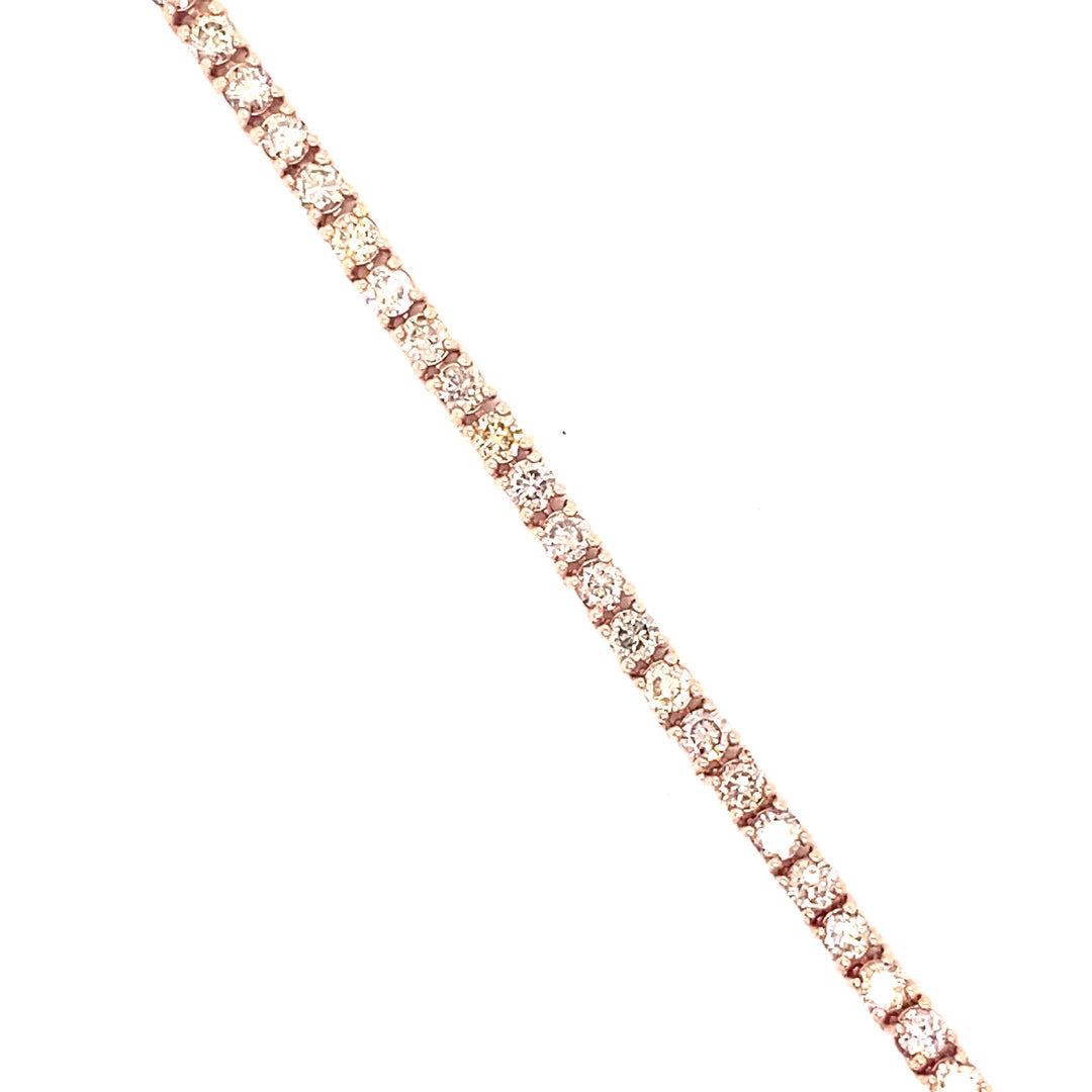 Rose gold and diamond tennis chain necklace featuring white VS clarity diamonds with button prongs holding up the diamonds.