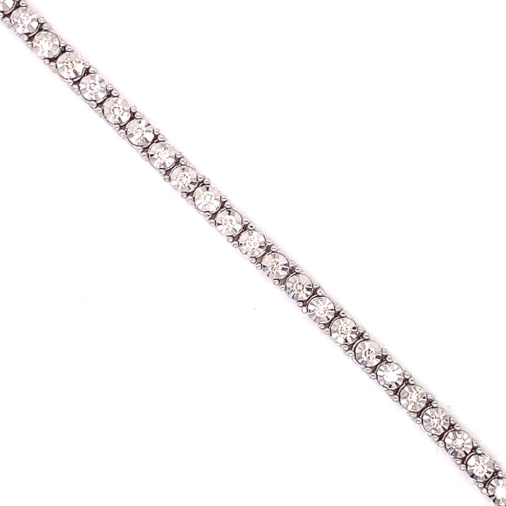 Built onto solid white gold, this tennis chain has white diamonds and button prongs. 