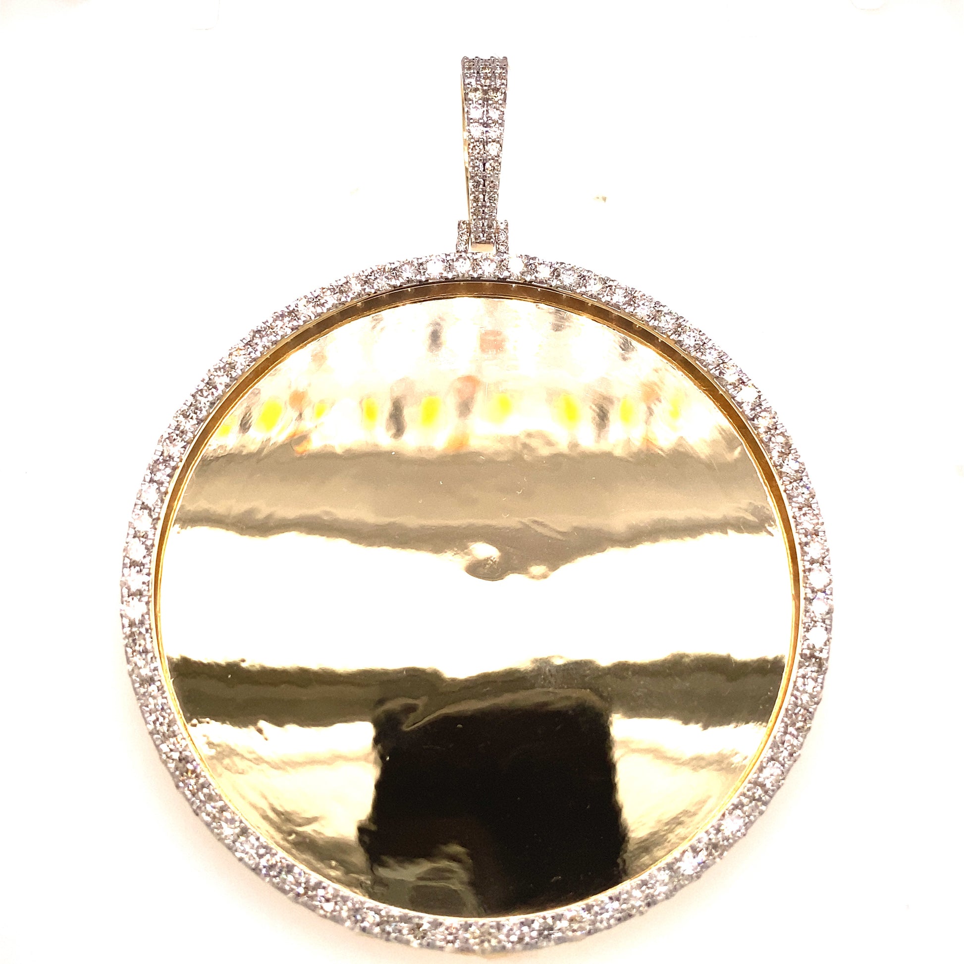 Large yellow gold and diamond photo pendant.