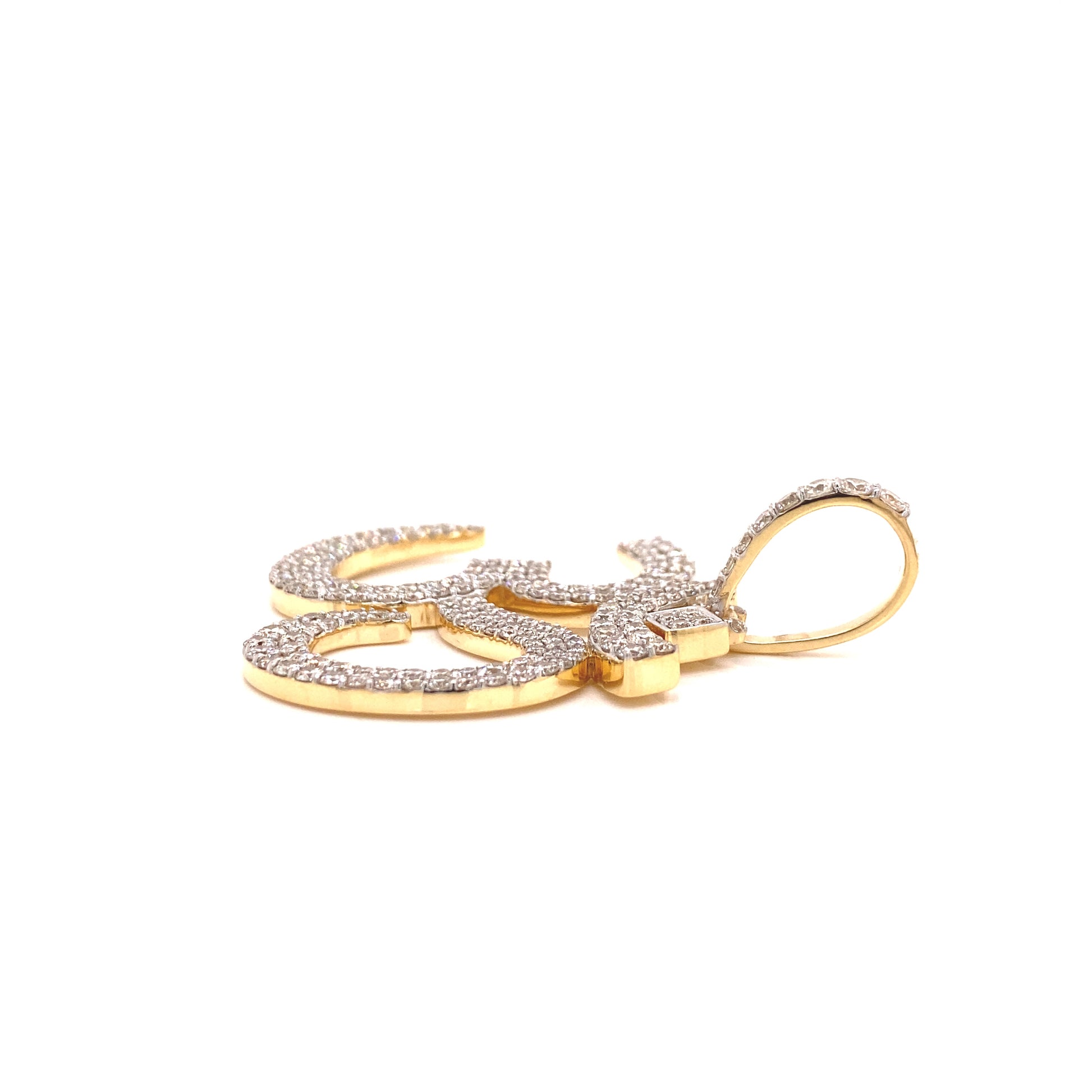 Yellow gold and diamond jewelry placed on a OM symbol. 