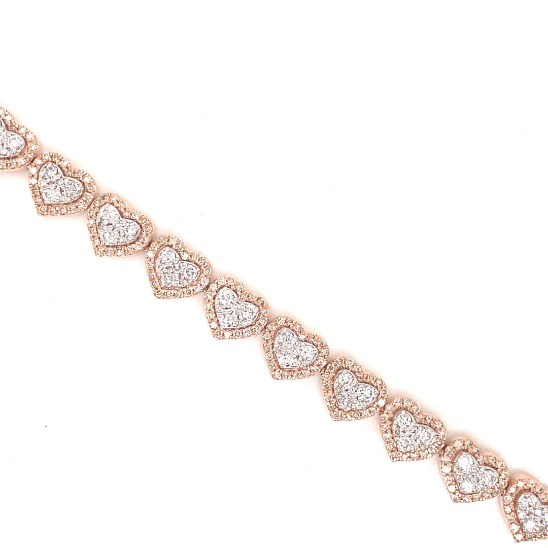 This heart bracelet is detailed with white and rose gold. The diamonds are set in a pave style with rose gold halo hearts.