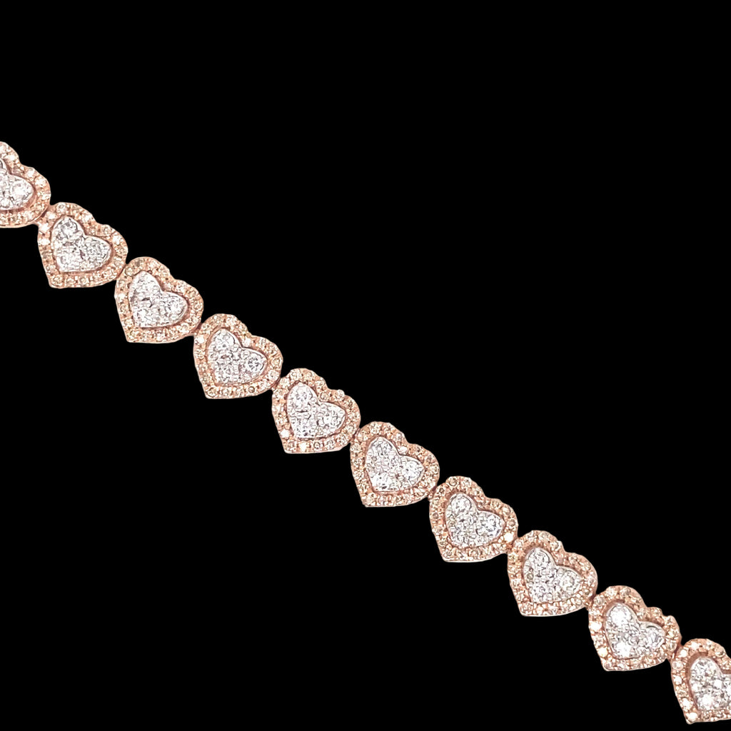 This heart bracelet is detailed with white and rose gold. The diamonds are set in a pave style with rose gold halo hearts.