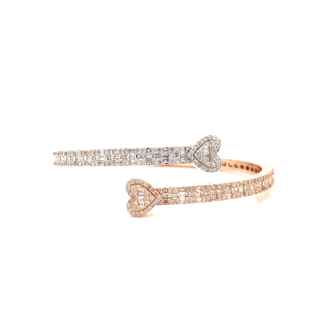 White and rose gold diamond bangle bracelet with heart shaped endings.