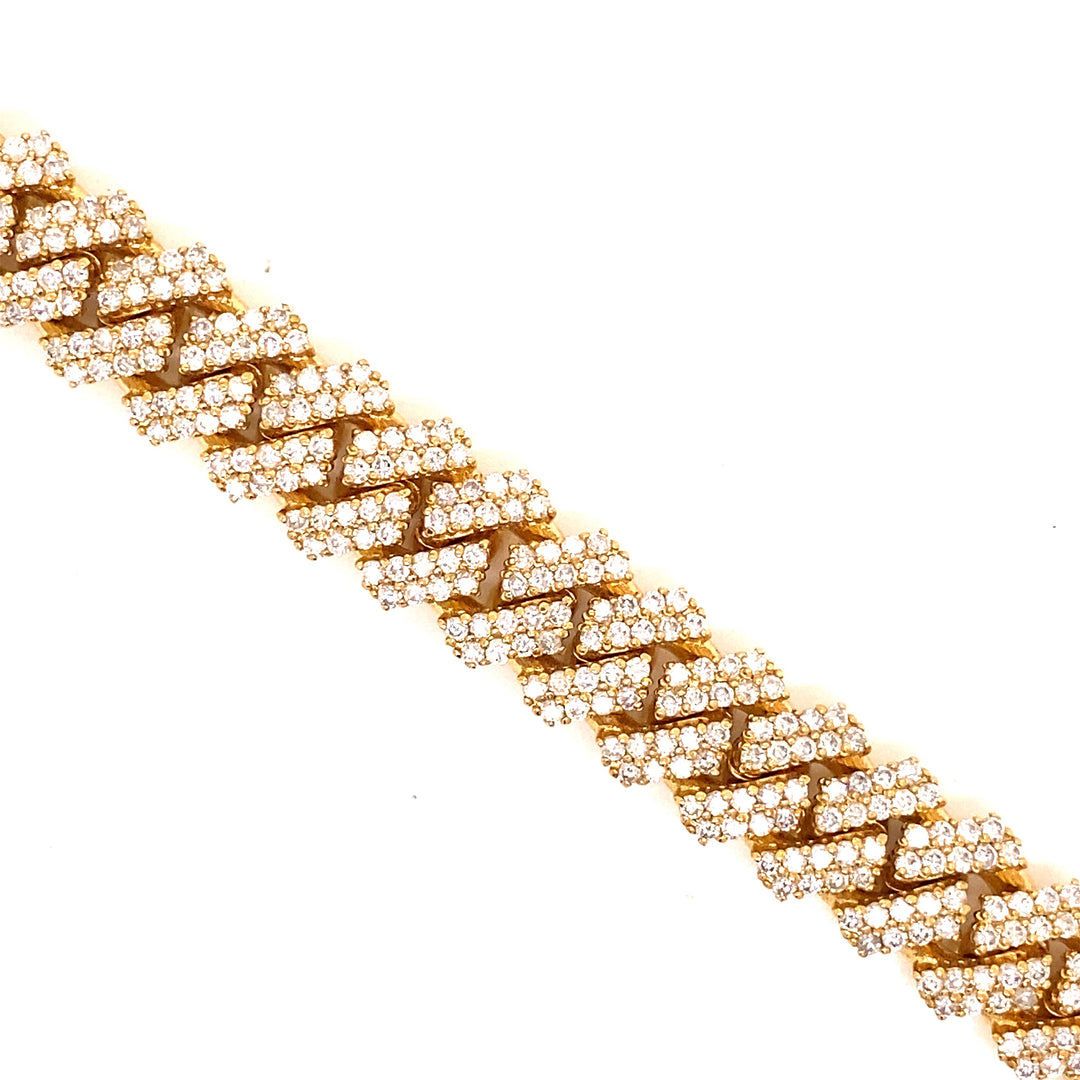 White diamonds are set in a pave style along this solid yellow gold bracelet.