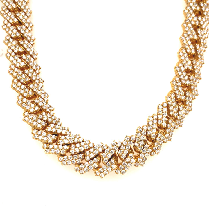 This yellow gold high rise Cuban link chain is finely detailed with white VS clarity diamonds.