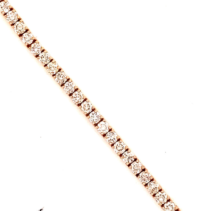 In this rose gold tennis bracelet, each diamond is encased with 4 button prongs. This is a classic style tennis bracelet.